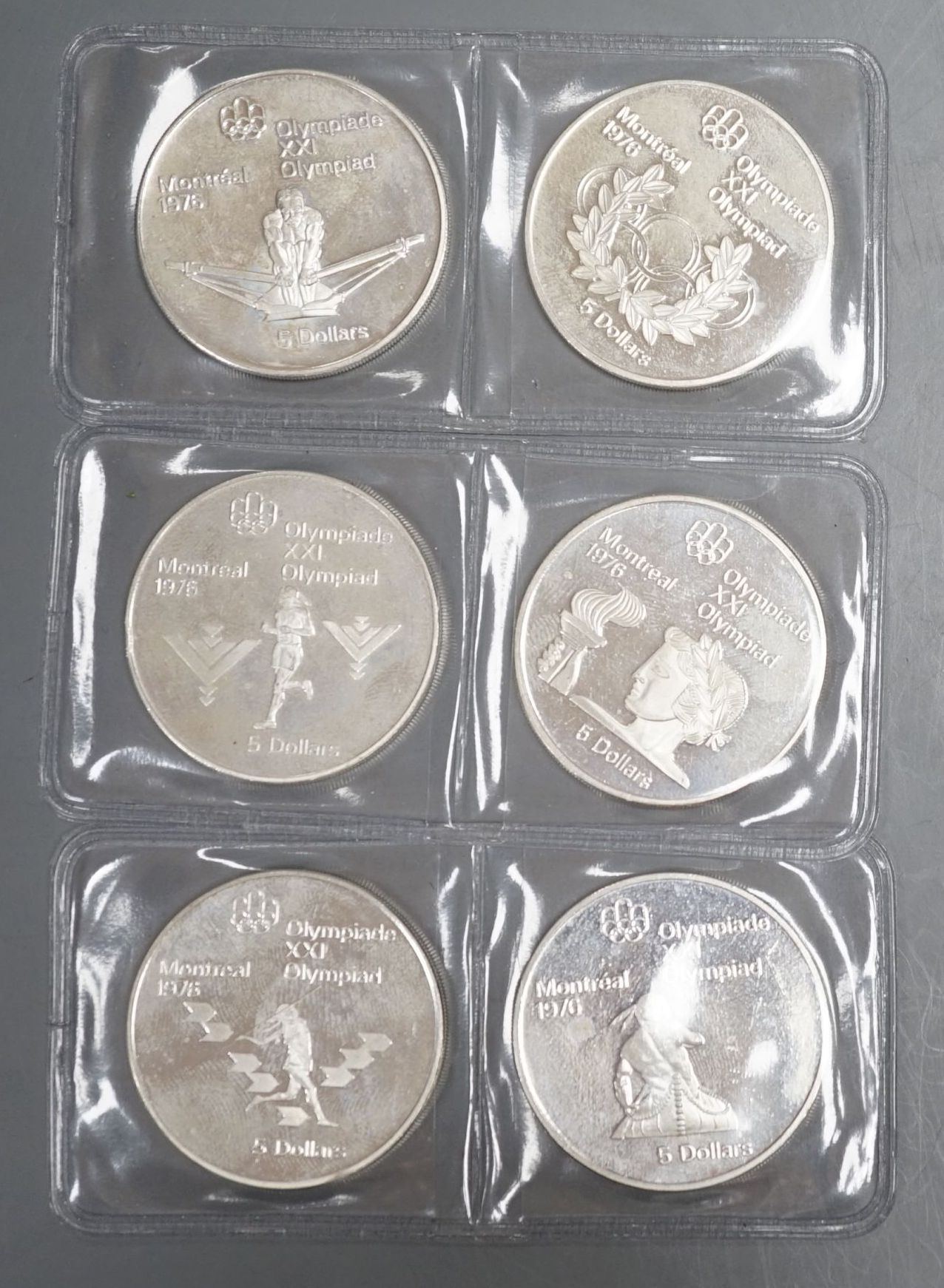 Six Canadian $5 silver Olympic Coins Montreal 1976 Games, total weight 146.4 grams.